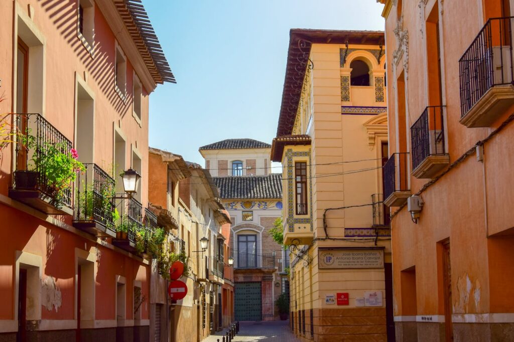 Picturesque street view in Mula, Murcia, Spain with colorful buildings and balconies.