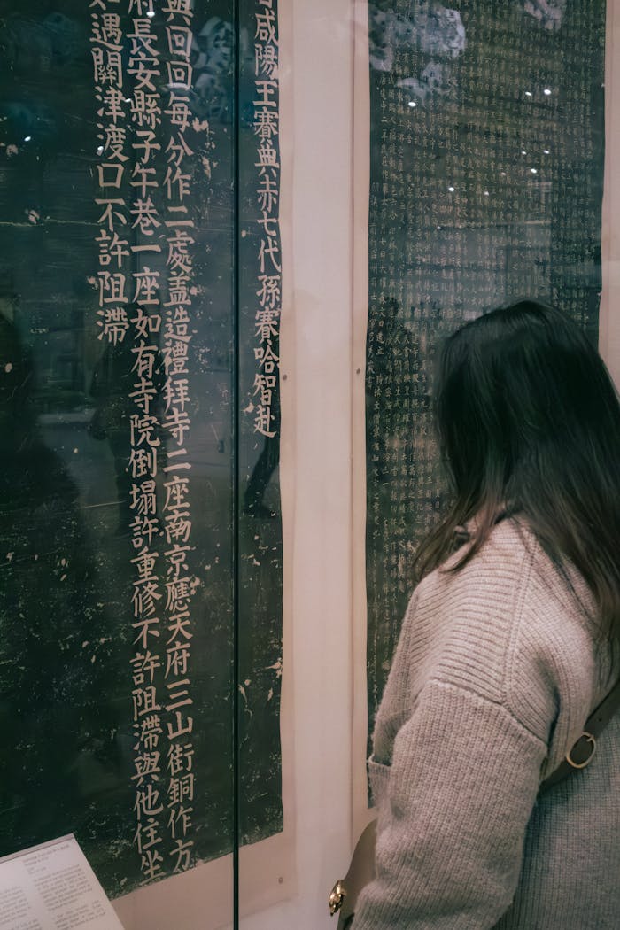A woman observes ancient Chinese calligraphy at a museum exhibit in Toronto.